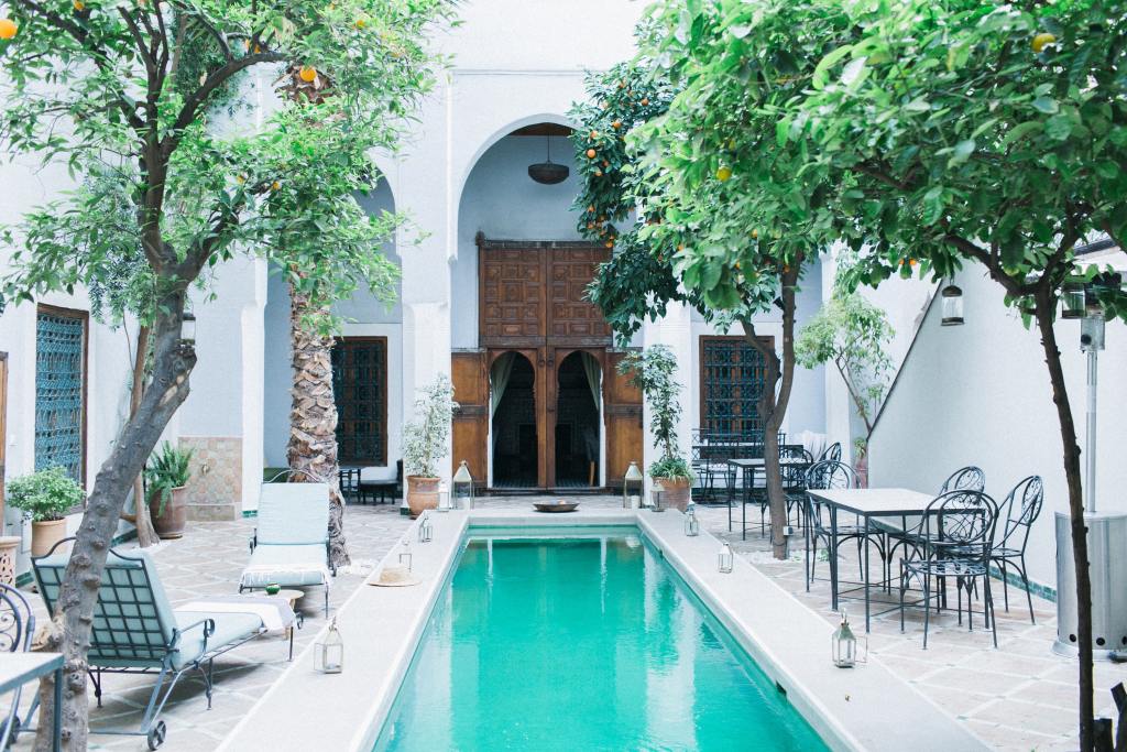 Chaise lounge chairs next to swimming pool