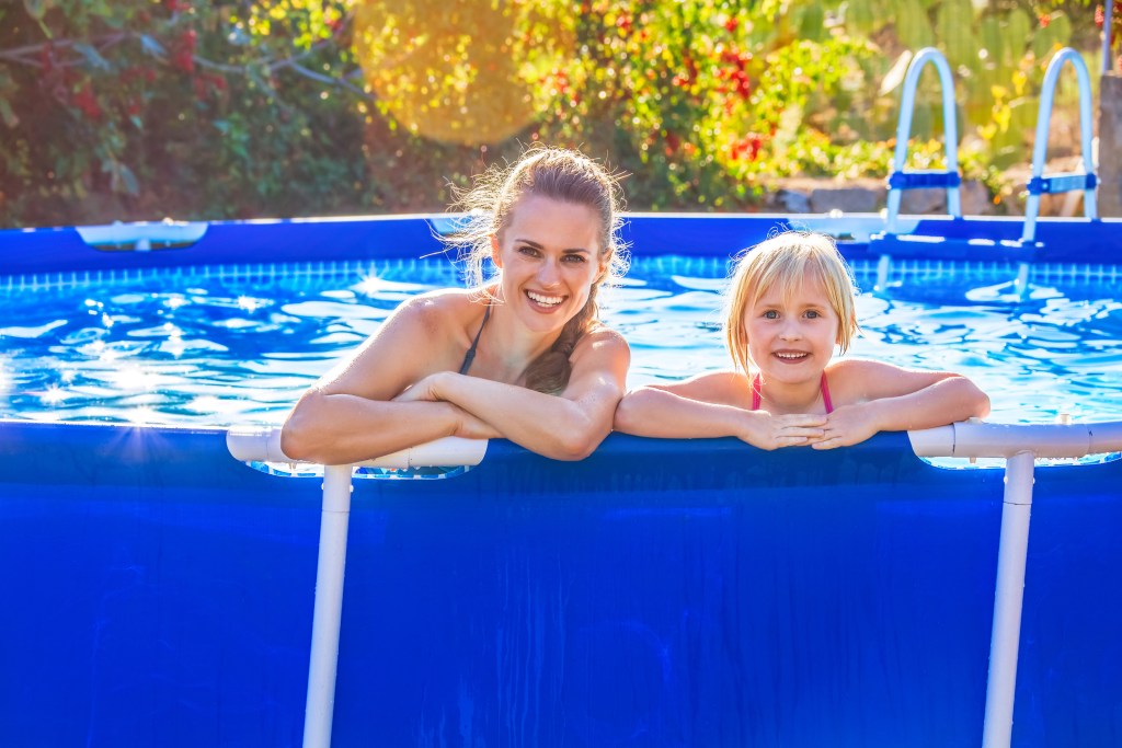 Mom and daughter enjoying above-ground pool