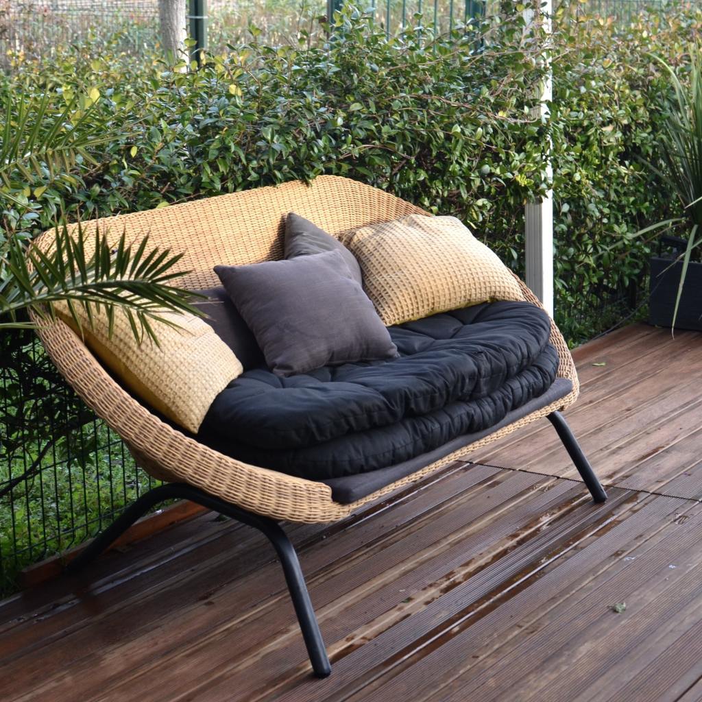Outdoor sofa with black cushions