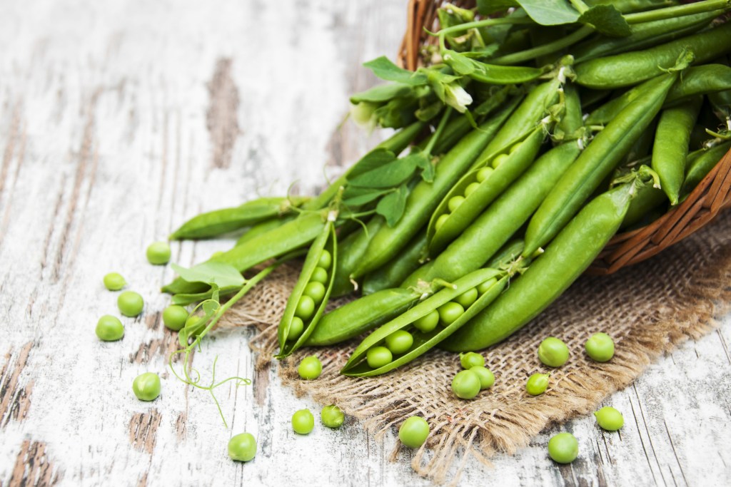 Green sugar snap peas on table