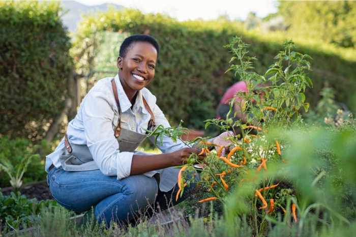 A woman happily tending to her garden