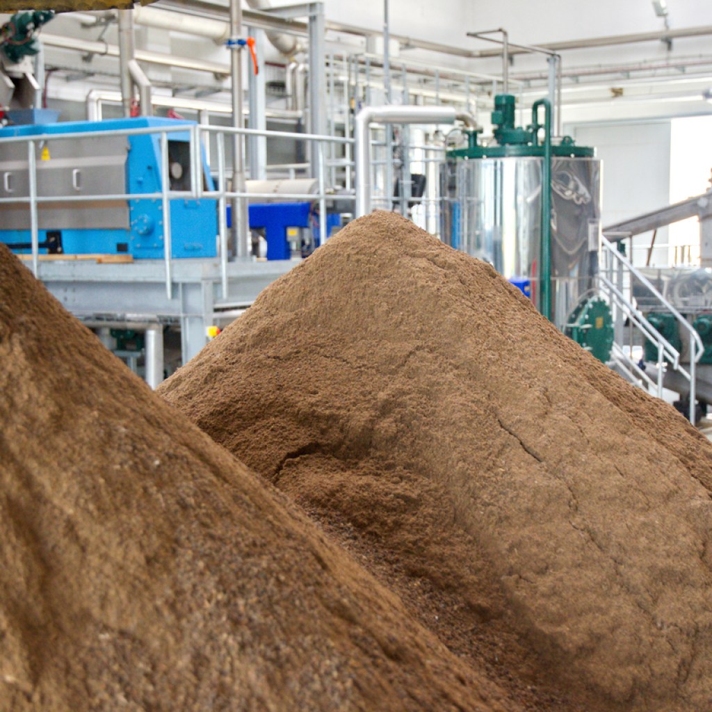 A pile of bone meal next to the equipment used to make it
