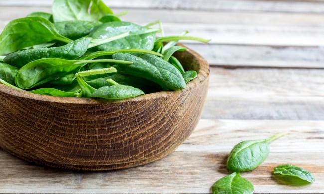 Freshly harvested spinach leaves in a bowl