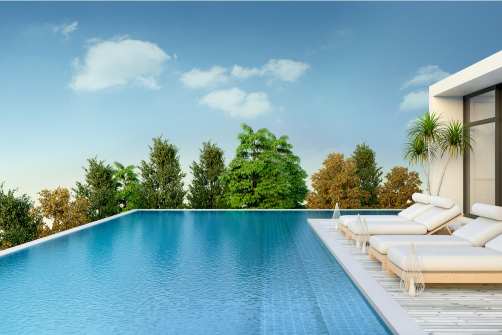 Lounge chairs set up next to a pool