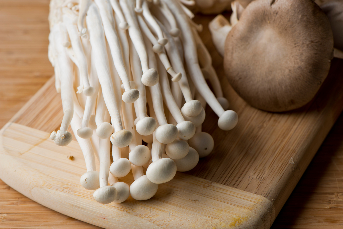 Enoki mushrooms on a cutting board
