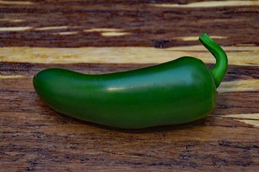A jalapeno on a wooden table