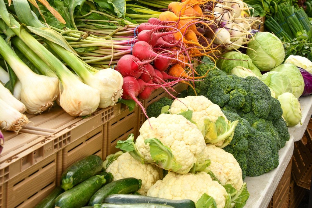 A farmers market stall selling vegetables
